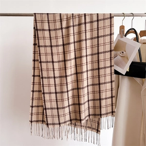 Classic beige plaid scarf with fringe, autumn cashmere-like warm shawl on a hanger