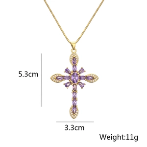 Detail shot of 18K gold plated cross necklace with purple zircon and white crystal