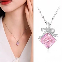 Detail of s925 silver necklace featuring a pink crystal perfume bottle pendant with bow