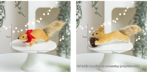 Detail of plush Christmas squirrel ornaments with pine cone and festive red bow accents