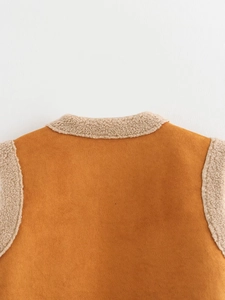 Detail view of orange faux suede vest with beige faux shearling lining and collar trim