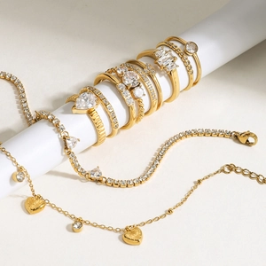 Macro view of gold-plated zircon ring set with heart pendant bracelet in luxury style