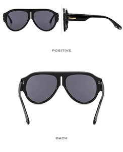 Three-view display of black pilot sunglasses with golden metal temple accents and grey lenses