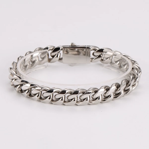 Detail of silver Cuban link bracelet made of polished stainless steel on a stand