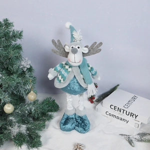 Detail of retractable Christmas reindeer doll with snowflake sweater on snowy base