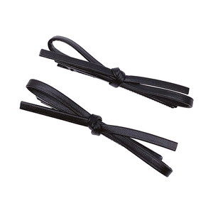 Pair of minimalist black leather bow hair clips for women with a sleek design