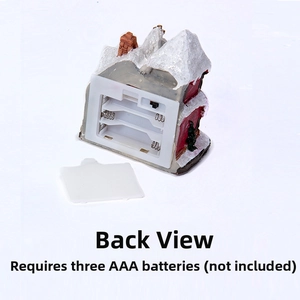 Rear view of Christmas snow house decoration with battery compartment and power switch