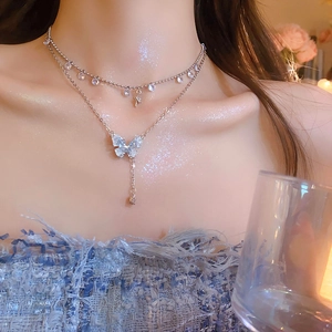 Double-layered silver butterfly tassel necklace with crystal accents and choker style