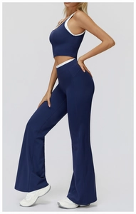 Detail of high-waisted navy yoga set with white contrast trim and flared leg design