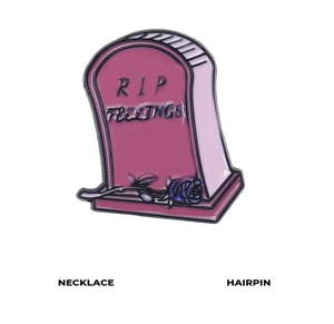 Detail of RIP FEELINGS enamel pin featuring a pink tombstone design with a blue rose