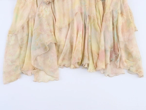 Detail of ruffle hem on floral chiffon skirt with layered asymmetric cut design