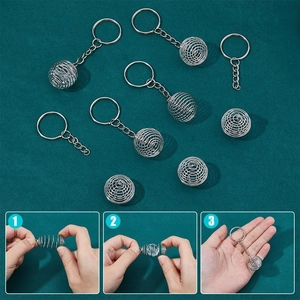 Detailed view of silver spiral cage pendants with keyrings for DIY jewelry making