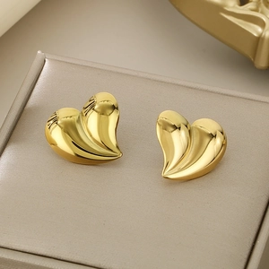 Minimalist irregular gold heart-shaped earrings in polished 18K titanium steel on box