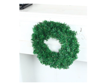 Close-up of artificial green PVC Christmas wreath with realistic pine needle texture