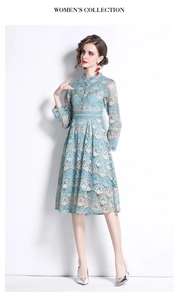Close-up of intricate light blue lace embroidery and elegant stand collar detail