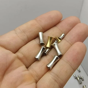 Handheld view of gold and silver stainless steel bamboo tube beads for DIY jewelry making