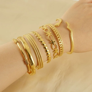 Set of 7 gold stainless steel adjustable bracelets featuring snake and link designs