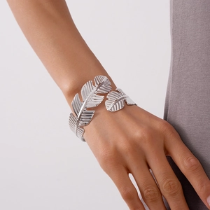 Detailed close-up of adjustable silver feather bangle showing intricate leaf textures