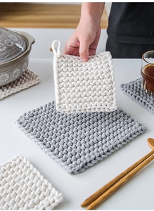 Detail of thick handwoven cotton coasters in cream and grey with hanging loops