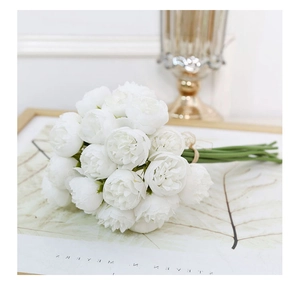 Close-up of white artificial tea rose bouquet tied with brown twine for wedding decor