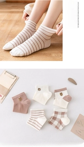 Close-up of high-elasticity cuffs on breathable cotton socks with bear embroidery
