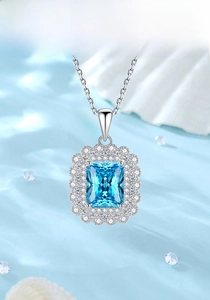 Detailed view of square blue gemstone pendant with S925 silver chain on silk backdrop