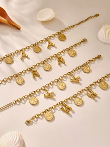 Detail of 18K gold plated stainless steel bracelets with alphabet and coin charms