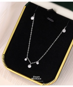 Close-up of S925 sterling silver necklace with five sparkling zircons in a jewelry box