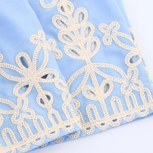 Light blue linen maxi dress with ivory floral embroidery and elegant hollow lace details