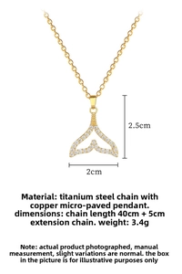 Detailed view of golden fishtail pendant with zircon stones and dimensions 2.5x2cm