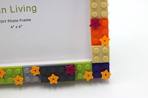 Close-up of colorful DIY building block photo frame corners with star shaped accessories