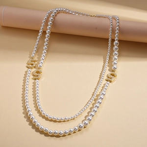 Elegant multi-layer pearl necklace featuring crystal-encrusted gold number five pendants