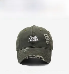 Detail of NABe NARA letter embroidery on olive green distressed denim baseball cap