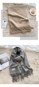 Close-up of solid color tassels and fabric texture on a warm polyester scarf