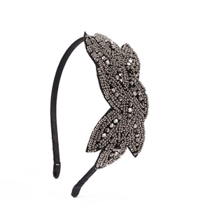 Detail of handcrafted bohemian headband with dark grey beads and sequins on black satin