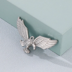Polished silver eagle pendant in minimalist style on a light blue geometric background