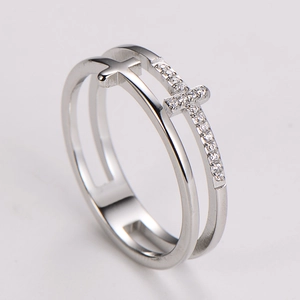 Macro view of silver stainless steel double layer ring with hollow cross and pavé crystals