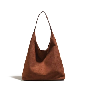 Detail shot of the deep caramel suede hobo tote bag with matching leather shoulder strap