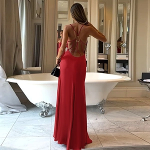 Detail of red backless vacation dress featuring crossover straps and metal ring connector