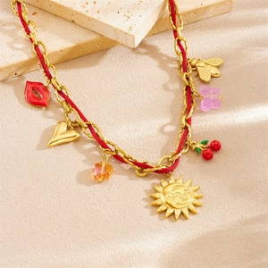 Golden chain and red cord necklace with sun, heart, lips, and cherry charms
