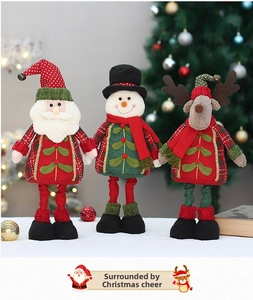 Close-up of Santa, Snowman, and Reindeer dolls in red and green festive plaid clothing