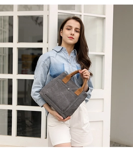 Casual canvas handbag for women with brown handles and front pocket, stylish daily tote bag.