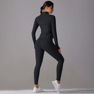 Rear view of sleek black slim-fit yoga set including long sleeve top and high waist leggings