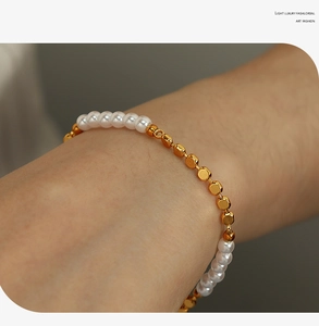 Detail of freshwater pearl bracelet with gold metal beads on a model wrist