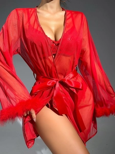 Detail of red sheer mesh robe featuring feather-trimmed cuffs and a satin waist belt
