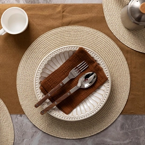 38cm round woven placemat with stainless steel cutlery and wooden handles on marble table