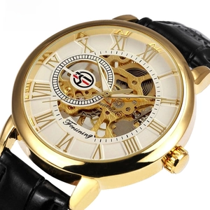 Close-up of skeleton dial showing gold gear movement and Roman numerals on mechanical watch