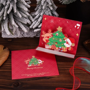 3D pop-up Christmas card with reindeer, Santa, and tree inside a red festive envelope