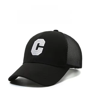 Detailed view of white towel embroidered C letter on breathable black mesh baseball cap