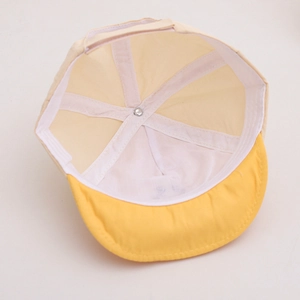 Detail view of the yellow visor kids cap showing internal sweatband and neat stitching